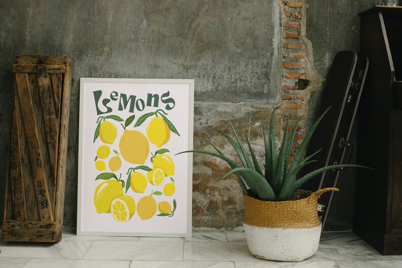 May include: A framed print with a white background and the word "Lemons" in green text. The print features a colorful illustration of lemons with green leaves.