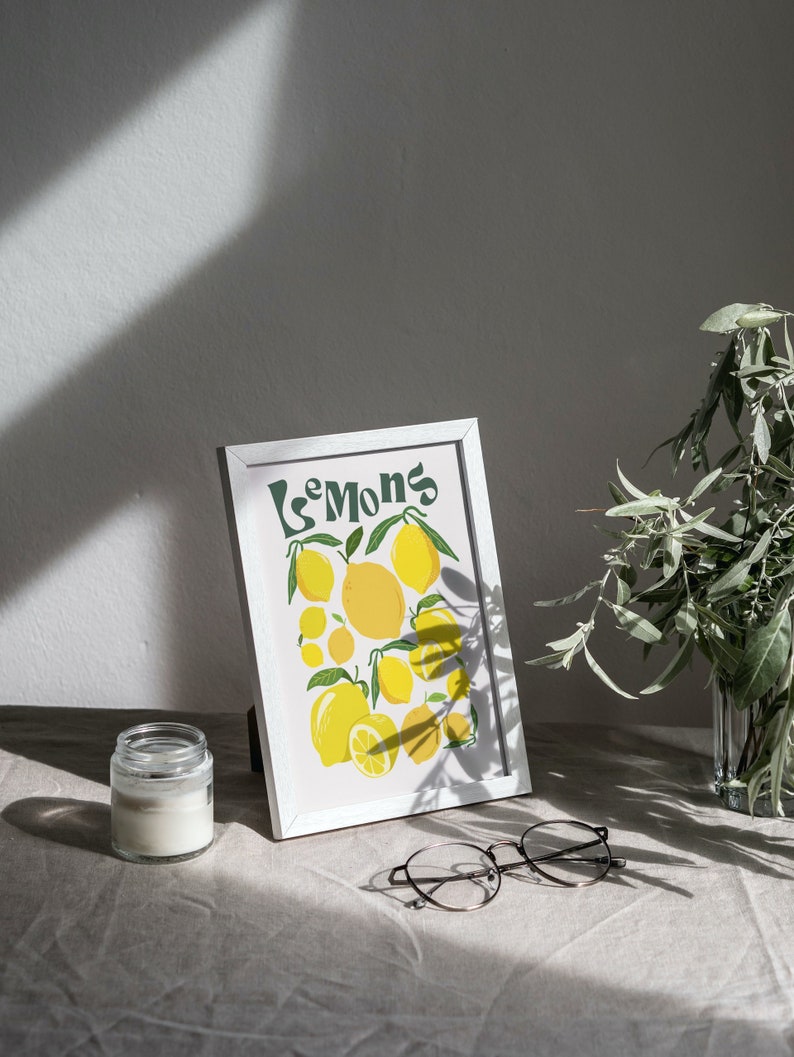 May include: A white framed print with the word "Lemons" in green lettering and a colorful illustration of lemons on a white background.