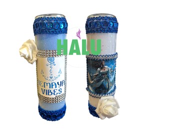 May include: Two blue and white tumblers with a white rose and a blue and white image of a woman. One tumbler has the text "YEMAYA VIBES" on it.