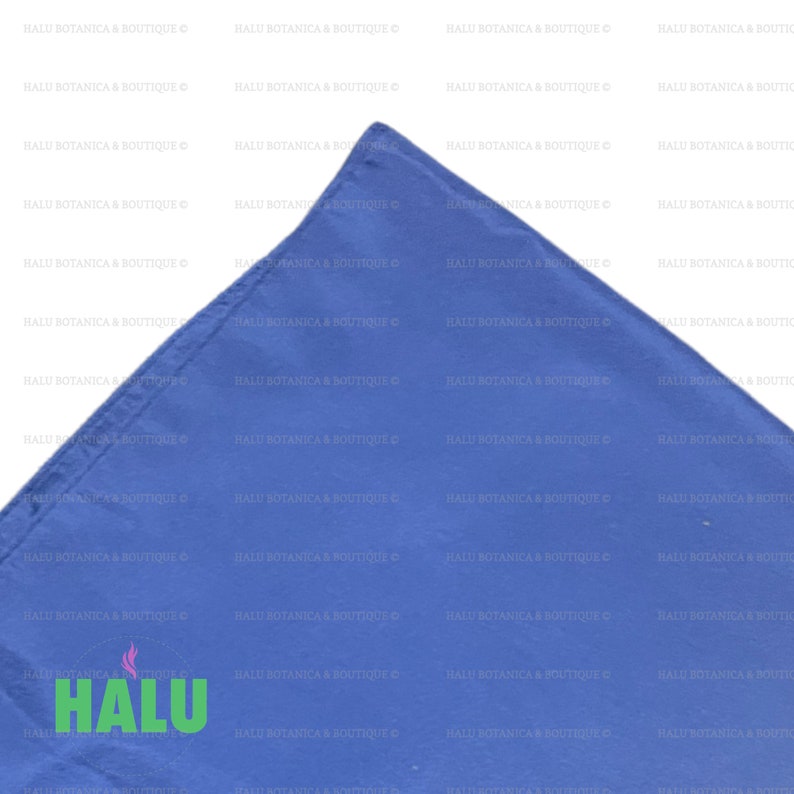 May include: A close-up of a corner of a solid blue fabric square with the text "HALU BOTANICA & BOUTIQUE" repeated in white text on the fabric.