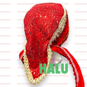 May include: A red sequined head covering with gold trim and a red satin tie. The head covering is folded in half and the tie is tied in a knot. The text "HALU" is visible in green letters.