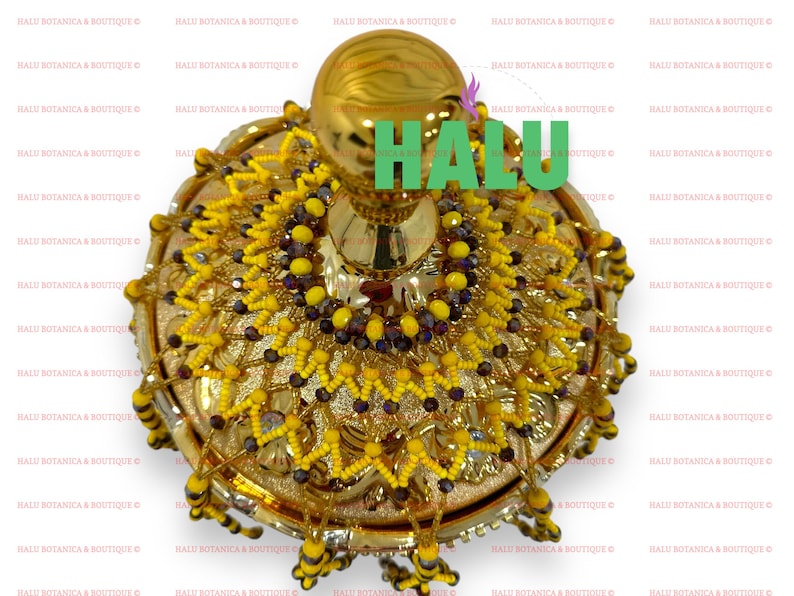 May include: A gold decorative bowl with a round top and a beaded design. The bowl is decorated with yellow and purple beads.