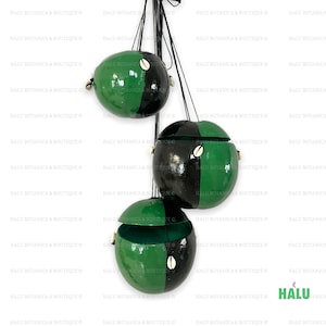 May include: Three green and black gourd-shaped containers with lids, hanging from black cords. The gourds are painted with a green and black design and have a small white shell attached to each.