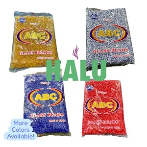 May include: Four bags of glass beads in gold, blue, red, and white. Each bag has the text "ABC GLASS BEADS MADE IN CHINA" in a circular logo. The image also includes the text "More Colors Available!" and the word "HALU".