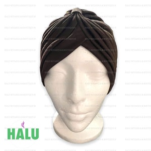 May include: A brown turban made of fabric with a crinkled texture. The turban is on a white mannequin head.
