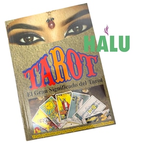 May include: A book titled "TAROT" with the text "El Gran Significado del Tarot" is displayed. The cover features a woman's eyes and a collection of tarot cards. The word "HALU" is visible in green.