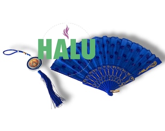 Op de afbeelding: Een blauwe handwaaier met gouden details en een blauwe kwastbedel. De waaier is gesloten en heeft een witte achtergrond.