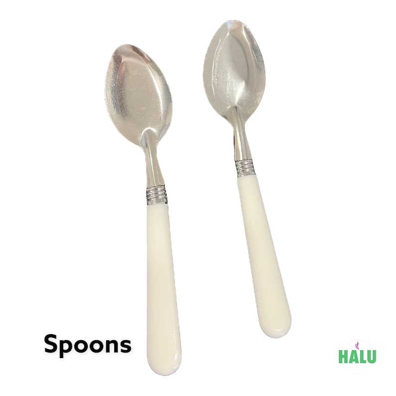 May include: Two white handled spoons with silver metal bowls. The spoons are arranged side by side on a white background. Spoons.