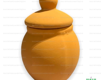 May include: A small, round, yellow ceramic jar with a lid. The jar has a smooth, matte finish.