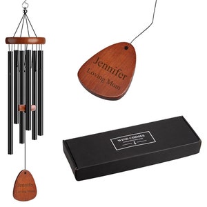 May include: A black metal wind chime with a wooden top and a personalised wooden tag that reads "Jennifer Loving Mom". The chime is packaged in a black box with the words "Wind Chimes" printed on it.