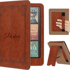 May include: A brown leather-like e-reader case featuring an embossed decorative border and the name Parker in script. The case includes a built-in stand and an elastic hand strap on the back, designed to hold an e-reader device securely.