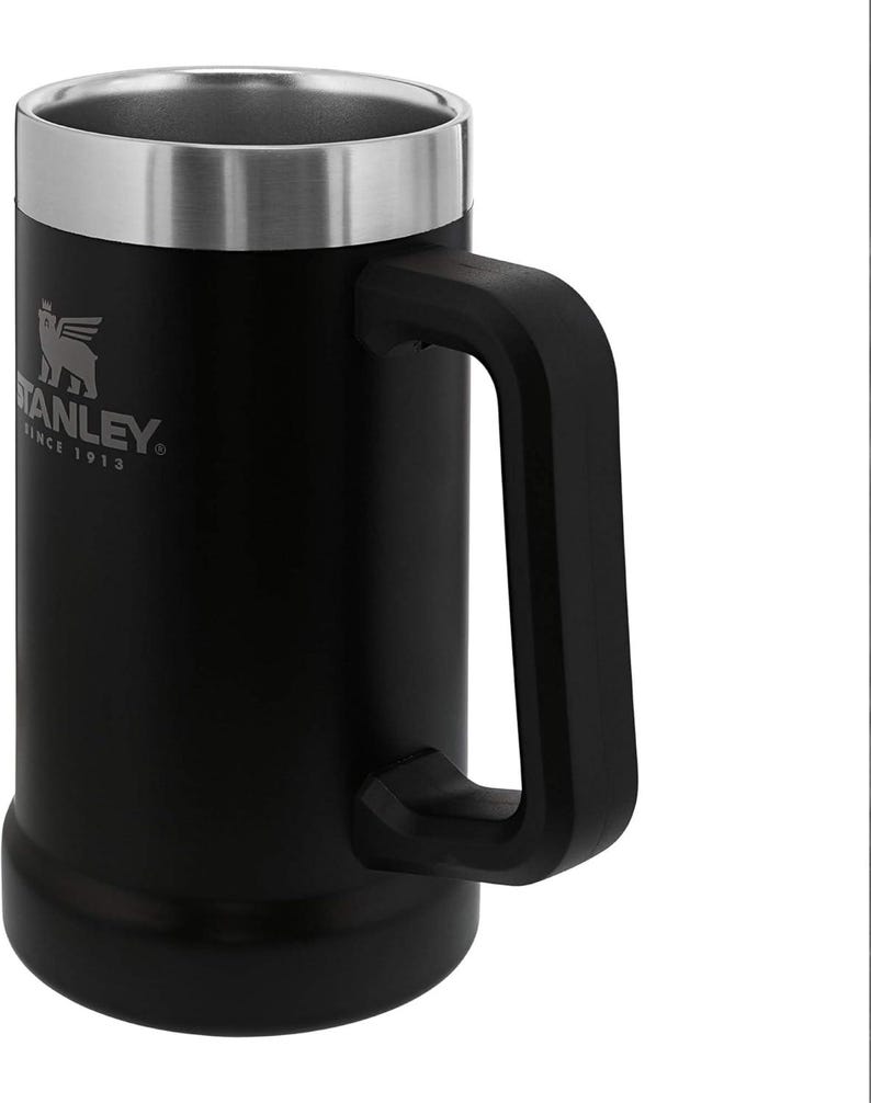 May include: Black Stanley beer stein with a silver rim and handle. The Stanley logo is visible on the front. The mug is made of stainless steel and has a large, sturdy handle.