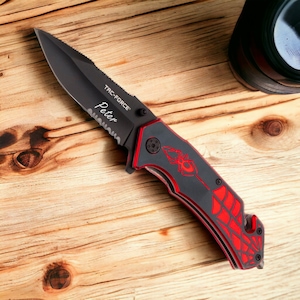 May include: Black folding knife with a red spider web design and the words "TAC-FORCE" and "Peter" engraved on the blade.