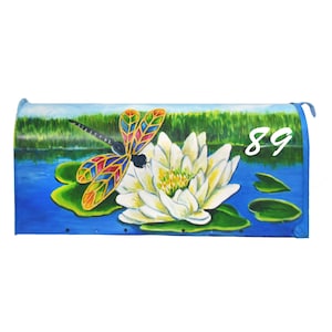 May include: A blue mailbox with a painted scene of a dragonfly on a white water lily with green lily pads. The number 89 is painted on the mailbox.