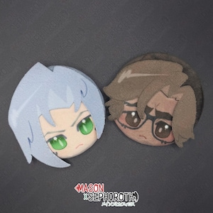 May include: Two circular plush character heads featuring stylized anime-inspired designs. One head has light blue hair and bright green eyes, while the other has brown hair, dark-rimmed glasses, and brown eyes. Text below reads MASON X SEPHIROTH.