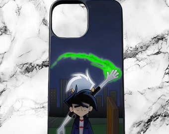 May include: A black phone case with a cartoon image of two characters from the animated series Danny Phantom. The characters are standing in front of a city skyline at night. One character is holding a green glowing orb.