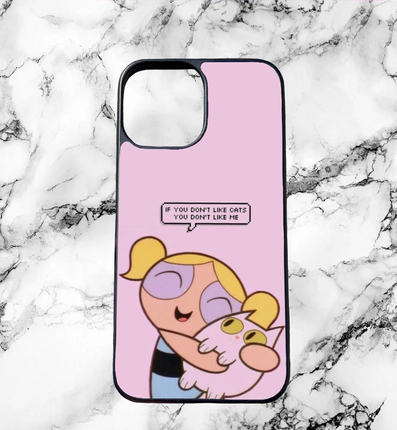 May include: Pink phone case with a cartoon image of a blonde girl holding a pink cat. The text on the case reads "If you don't like cats you don't like me."