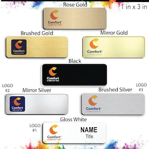 May include: A variety of name badge designs for Comfort Inn & Suites hotels. The badges are available in rose gold, brushed gold, mirror gold, black, mirror silver, brushed silver, and gloss white. Each badge is 1 inch by 3 inches and features the Comfort Inn & Suites logo. The badges also include space for a name and title.