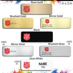 May include: A selection of Salvation Army name badges in various finishes, including rose gold, brushed gold, mirror gold, black, mirror silver, brushed silver, and gloss white. The badges are 1 inch by 3 inches and feature the Salvation Army logo and the phrase "Doing the Most Good".