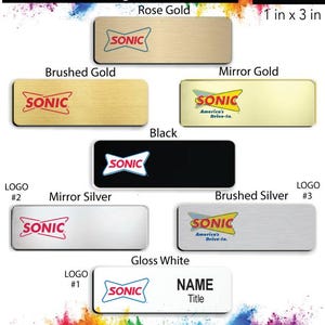 May include: A variety of name badge designs for Sonic Drive-In employees. The badges are available in different colors and finishes, including brushed gold, mirror gold, black, mirror silver, brushed silver, and gloss white. The badges feature the Sonic logo and the text "America's Drive-In." The badges are 1 inch by 3 inches.