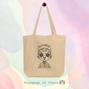 Puede incluir: Bolso tote beige con una ilustración en blanco y negro de un personaje parecido a un búho con la palabra "OWLTERNATIVE" encima de la cabeza. El texto "Pedagogy of Chaos" está en la parte inferior.
