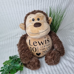 May include: A brown plush monkey with a black embroidered heart and the text "Lewis 10 pounds 11:47pm 15th Aug 2021" on its chest.