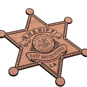 May include: A wooden sheriff's star badge with the text "SHERIFF STATE OF LOUISIANA EAST BATON ROUGE LA" and a state seal with a pelican.