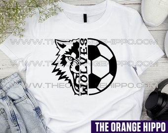 May include: White t-shirt with a black and white graphic of a wolf's head and a soccer ball. The text "WOLVES" is written vertically on the wolf's head. The graphic is split down the middle, with the wolf's head on the left and the soccer ball on the right.