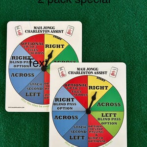 May include: Two white circular game boards with colorful sections and a black arrow pointer. The boards are for the game Mah Jongg and are labeled "Charleston Assist". The text on the boards includes "Optional up to 3 tiles across", "Right", "Across", "Left", "Blind Pass Option", "Stack Second Left", "Option to Stop Passing & Jump to Optional".