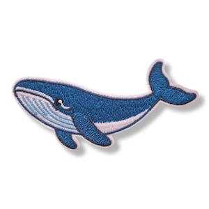 Op de afbeelding: Een geborduurde patch in de vorm van een blauwe vinvis met een donkerblauw lichaam en een lichtblauw en wit gestreepte buik. De walvis is afgebeeld in zwempositie met een zichtbaar oog, een borstvin en een staartvin, afgewerkt met een witte rand.