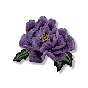 May include: Embroidered purple flower patch with green leaves and a gold center. The floral patch is a detailed design, perfect for adding to clothing or accessories. The patch is on a white background.