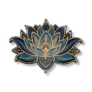 May include: Embroidered lotus flower patch in shades of blue, gold, and black. The patch features intricate stitching and a detailed design, perfect for adding to clothing or accessories. The lotus flower is a symbol of purity and enlightenment.