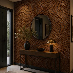 May include: A rectangular wooden console table with a black metal frame stands against a wall featuring a textured, circular brick pattern. On the table sits a black vase with green foliage, a black bowl, and a brass-toned dome-shaped table lamp.
