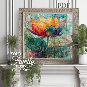 Peut inclure: Une impression encadrée à l'aquarelle d'une fleur de lotus. La fleur a des pétales orange, rouges et violets avec des feuilles vertes. Le fond est un mélange de teintes vertes et bleues. Le texte "Your Family Print Cross Stitch" est visible.