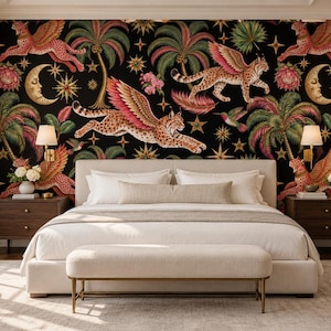May include: A bedroom featuring a black wallpaper with a repeating pattern of winged leopards, palm trees, crescent moons, and stars. The room includes a white upholstered bed, a matching bench, two dark wood nightstands, and wall-mounted lamps.