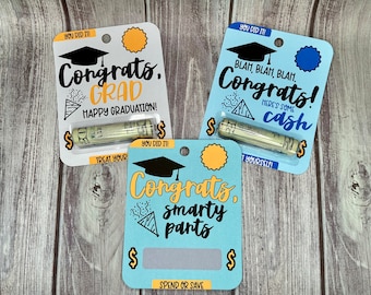 May include: Three graduation gift cards with blue and yellow backgrounds. Each card has a graduation cap, confetti, and a slot for cash. The text on the cards reads "Congrats, Grad", "Blah, Blah, Blah, Congrats! Here's some cash", and "Congrats, Smarty Pants".