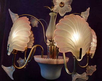 Rococo chandelier is a golden ceiling lamp with curves and decorative elements flowers and shells