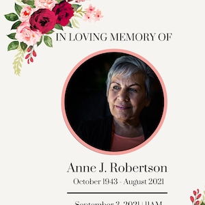 Op de afbeelding: Een herdenkingskaart met een foto van een vrouw, omringd door rode en roze bloemen. De tekst luidt "In liefdevolle herinnering aan Anne J. Robertson, oktober 1943 - augustus 2021, 3 september 2021 | 11:00 uur, Christ the King Catholic Church."