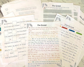 May include: A stack of white paper worksheets with text and fill-in-the-blank sections. The worksheets are titled "The Creed" and feature religious educational content. Some worksheets have images.