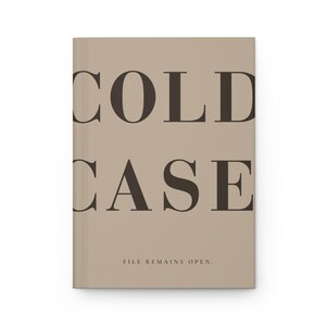May include: A hardcover journal with a light tan cover featuring the words COLD CASE in large, dark brown serif capital letters. Below the main text, the phrase FILE REMAINS OPEN. is printed in smaller, dark brown, capitalized serif font.