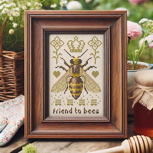 May include: A framed cross-stitch design featuring a bee with a crown above it and the text "friend to bees".