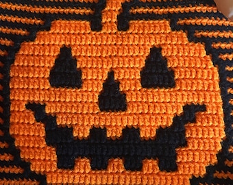May include: A crochet pattern for a Jack O' Lantern, featuring a black and orange design. The pattern is 49 stitches wide and 41 stitches tall. It includes both striped and unstriped variations.