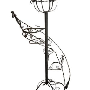 May include: A black metal plant stand with a spiral design and multiple tiers. The stand has a decorative base and a top tier that is shaped like a bowl.