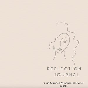 May include: A journal with a minimalist design. The cover is a light beige color with a line drawing of a woman's face and the words "REFLECTION JOURNAL". Below the title is the text "A daily space to pause, feel, and reset."