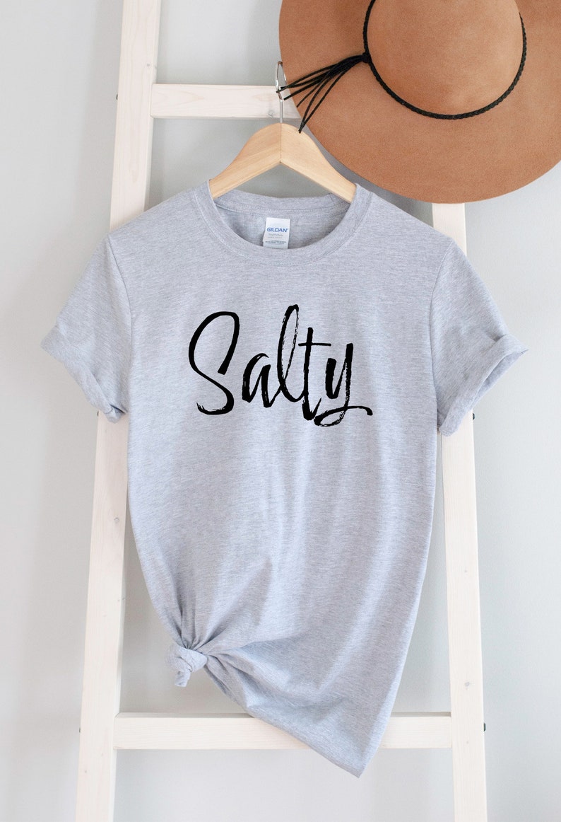 May include: Gray t-shirt with the word "Salty" written in black script.