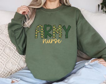 May include: A green sweatshirt with the words "ARMY nurse" in yellow letters with a sunflower pattern. The letters are outlined in black.