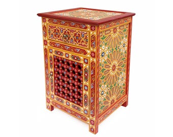 May include: A hand-painted wooden bedside table with intricate geometric and floral patterns in red, yellow, green, and blue. The table features a drawer, a door with a lattice design, and a decorative top.