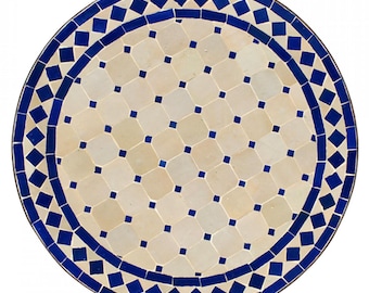 May include: Round table top with a white and blue mosaic tile design. The center of the table top features a repeating pattern of small blue squares within larger white squares. The border of the table top features a repeating pattern of blue diamonds.