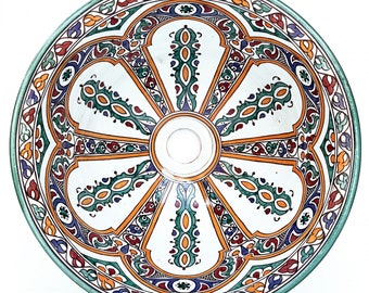 May include: A white ceramic bowl with a green rim and intricate floral patterns in shades of orange, green, blue, and red.