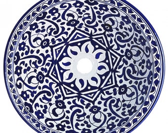 May include: A white ceramic sink with a blue and white floral pattern. The sink has a round shape and a hole in the center for the drain.